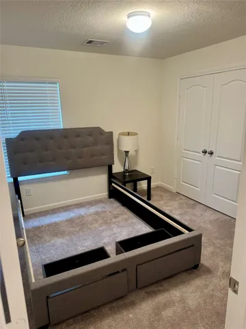 a living room with stainless steel appliances granite countertop furniture and a rug