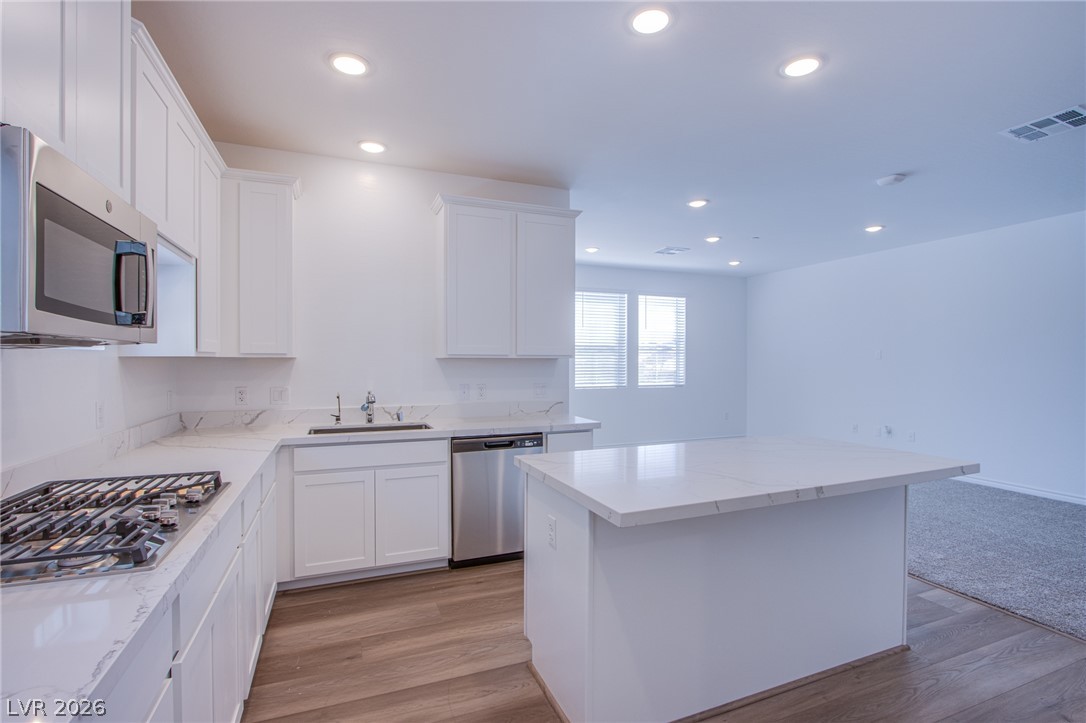 2555 Hampton Road, Unit 8201 Henderson, NV 89052 - Photo 32 of 33 Gleaming stone counters and sleek white cabinetry define this airy kitchen layout.