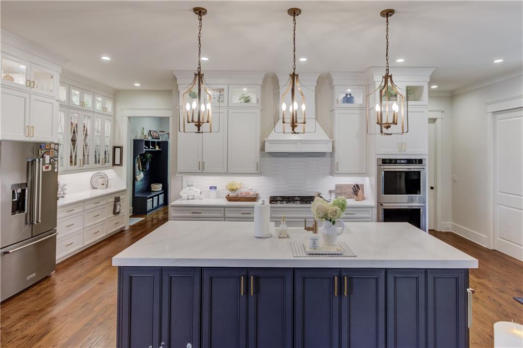 1894 Point River Drive Duluth, GA 30097 - Photo 3 of 17 a kitchen with stainless steel appliances a kitchen island a stove a refrigerator a sink a counter and cabinets