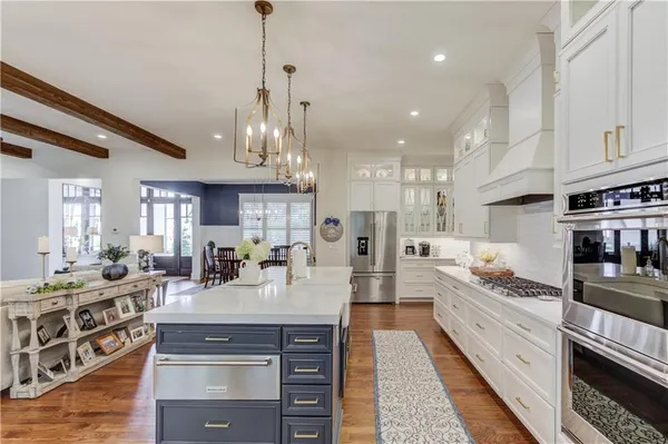 a kitchen with stainless steel appliances kitchen island granite countertop a lot of counter top space