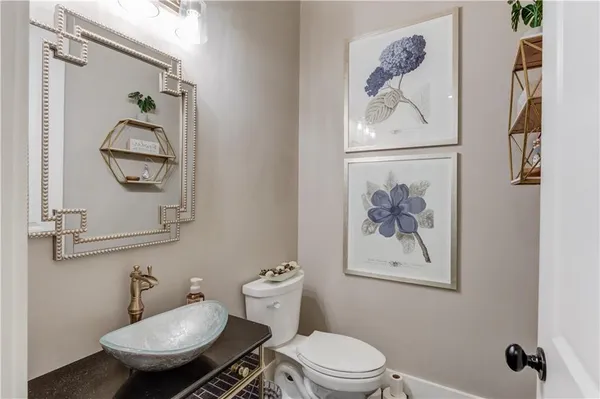 a white toilet sitting next to a bathroom sink