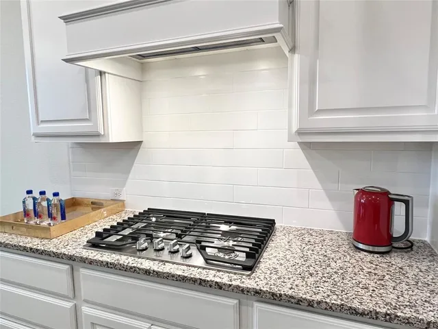 a stove top oven sitting inside of a kitchen