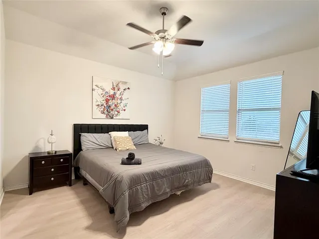a bedroom with bed and window