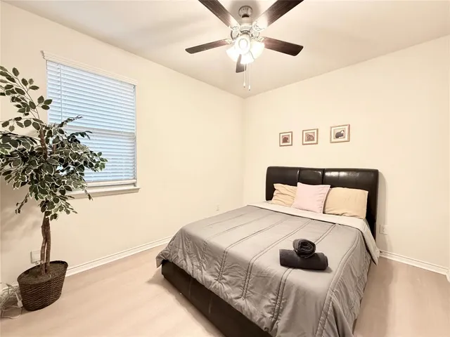 a bedroom with a bed and a potted plant