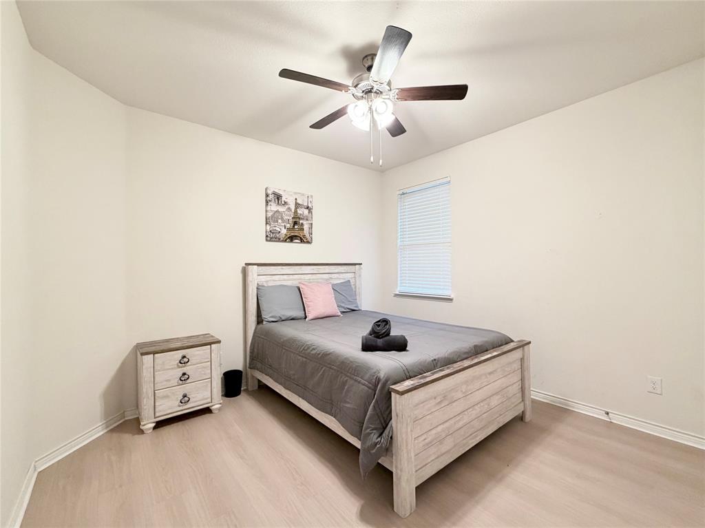 1041 Sublime Drive Forney, TX 75126 - Photo 21 of 26 a bedroom with a bed and a ceiling fan