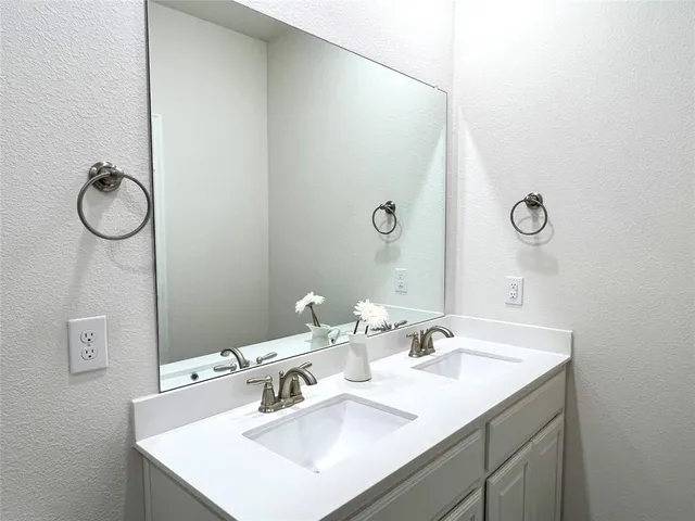 a bathroom with a sink and mirror