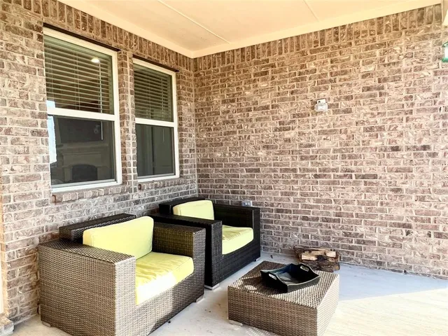 a view of a patio with couches chairs and a stove