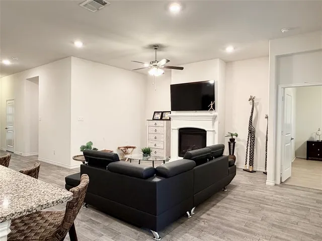 a living room with furniture a fireplace and a flat screen tv