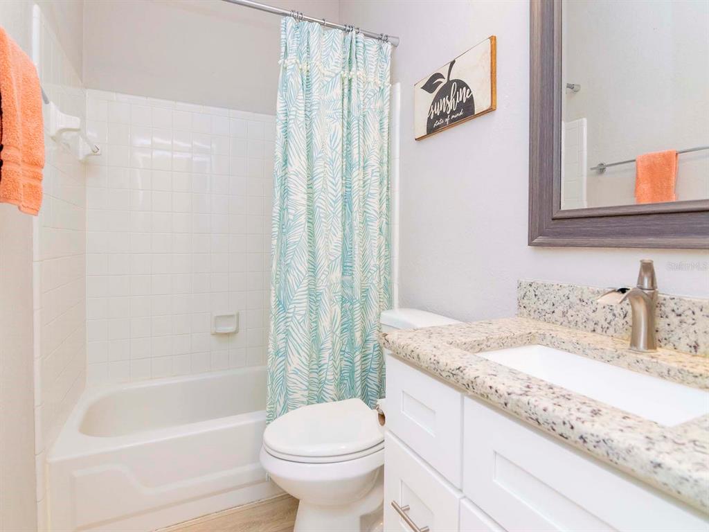 1036 Normandy Trace Road Tampa, FL 33602 - Photo 19 of 31 a bathroom with a granite countertop sink toilet and shower