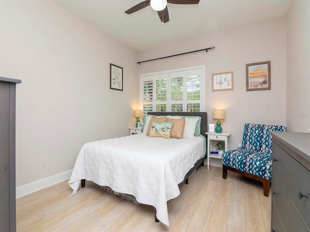 1036 Normandy Trace Road Tampa, FL 33602 - Photo 20 of 31 a bedroom with a bed and a chandelier
