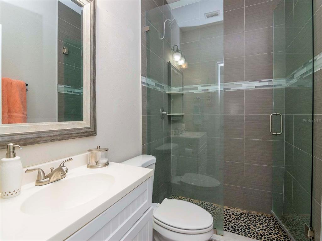 1036 Normandy Trace Road Tampa, FL 33602 - Photo 21 of 31 a bathroom with a sink a toilet and shower