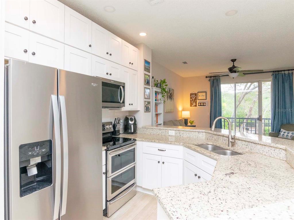 1036 Normandy Trace Road Tampa, FL 33602 - Photo 7 of 31 a kitchen with granite countertop a refrigerator stove top oven and sink