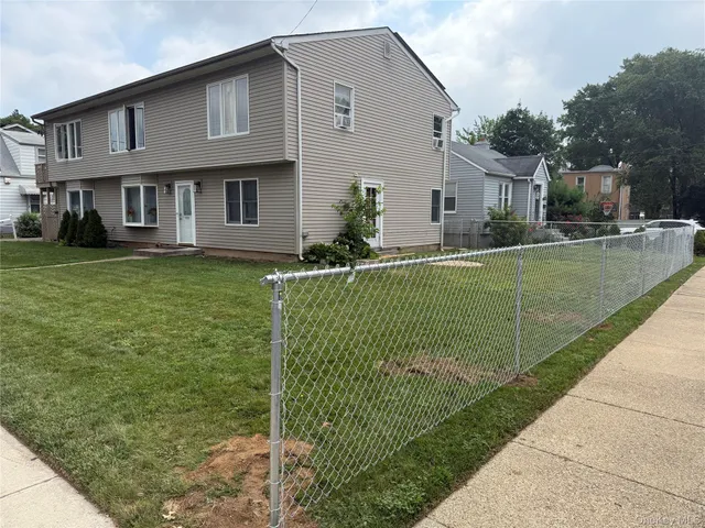a view of a house with a backyard