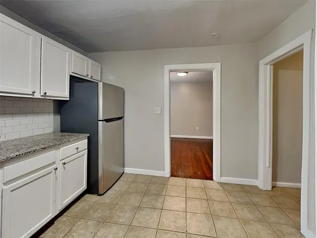 a kitchen with a refrigerator and a sink