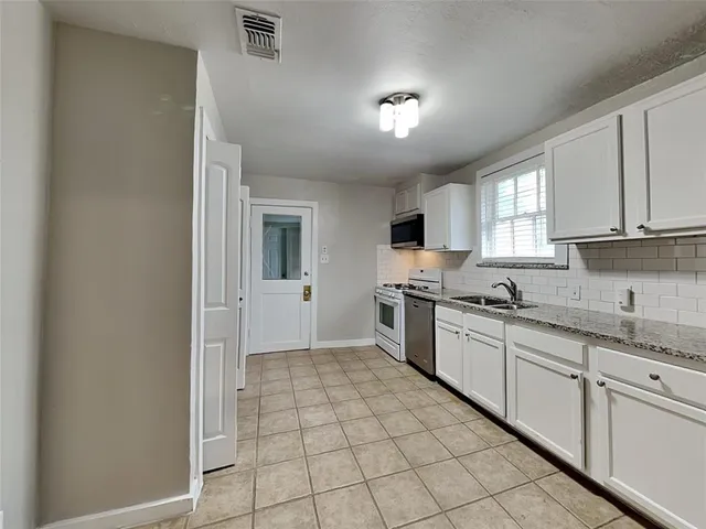 a view of a room with wooden floor and a window