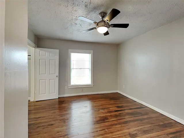 a view of an empty room and wooden floor