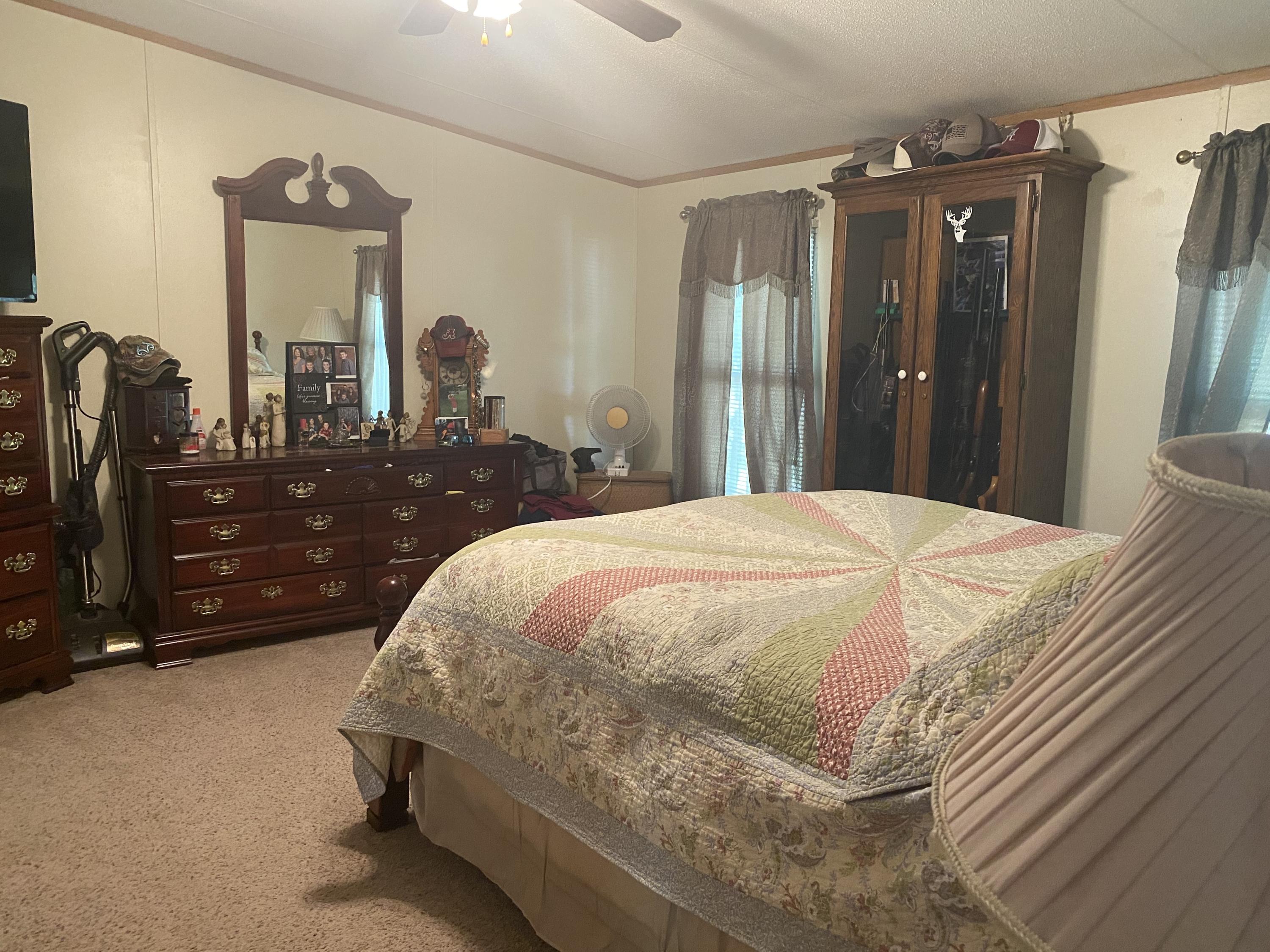 106 Brake Road Elliston, VA 24087 - Photo 4 of 13 a bedroom with a bed mirror and dresser