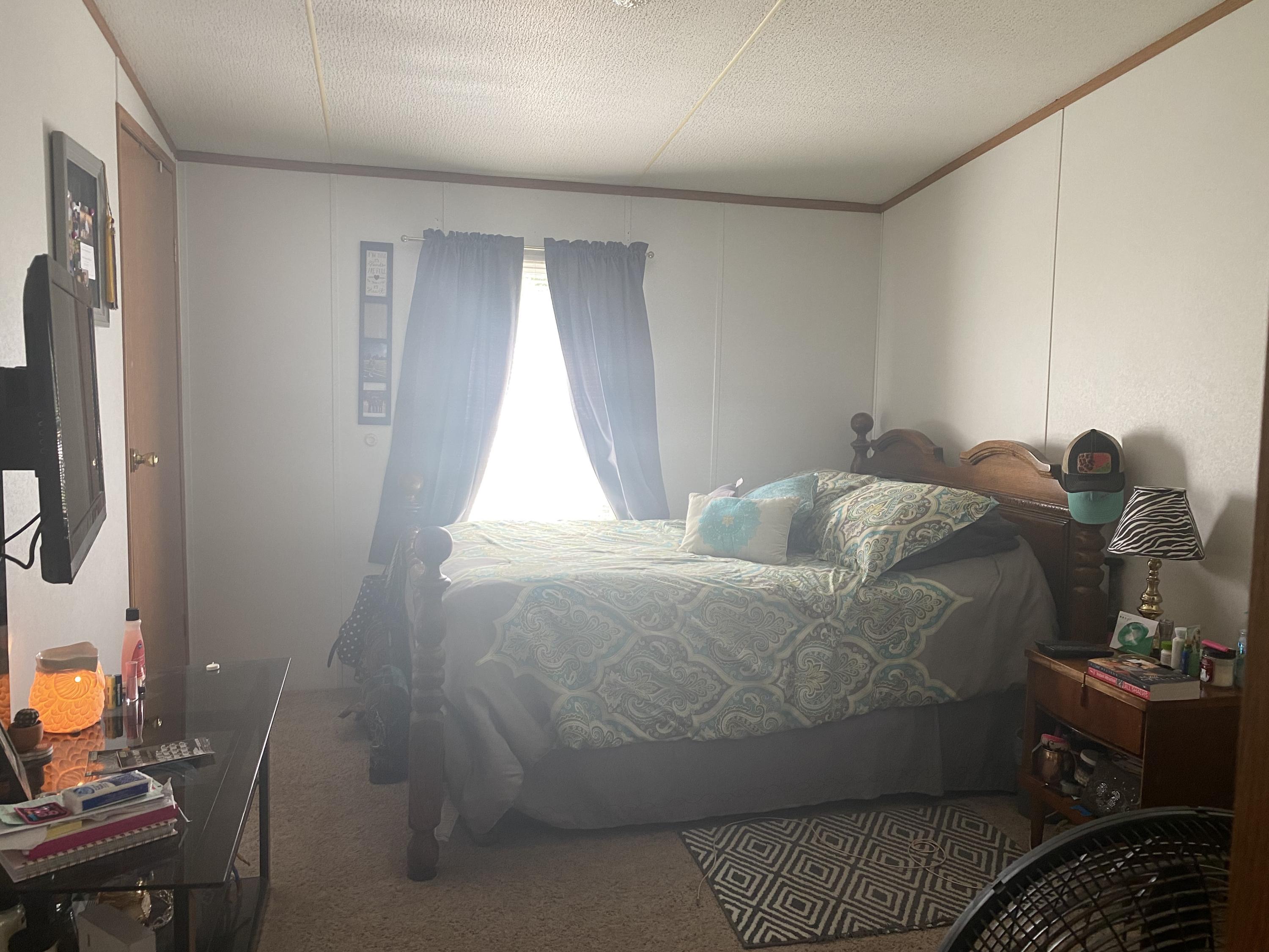 106 Brake Road Elliston, VA 24087 - Photo 5 of 13 a bed sitting in a room next to a window