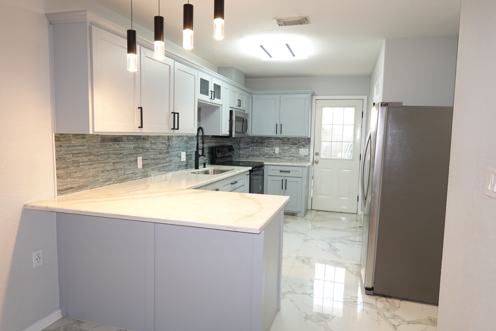 2714 Vienna Place Pasadena, TX 77502 - Photo 2 of 12 a kitchen with kitchen island a sink stainless steel appliances counter space and cabinets