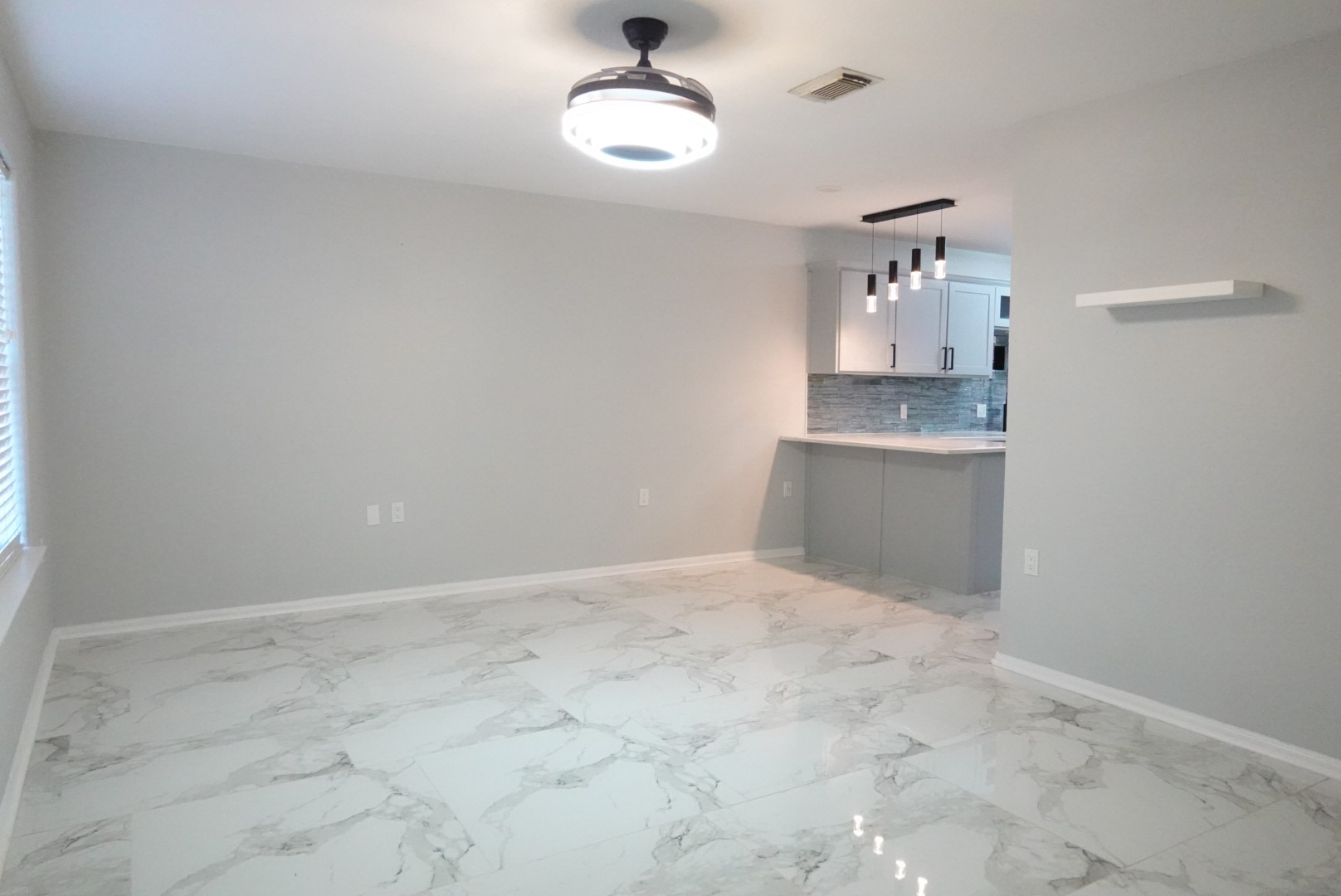 2714 Vienna Place Pasadena, TX 77502 - Photo 5 of 12 an empty room with chandelier fan and kitchen view