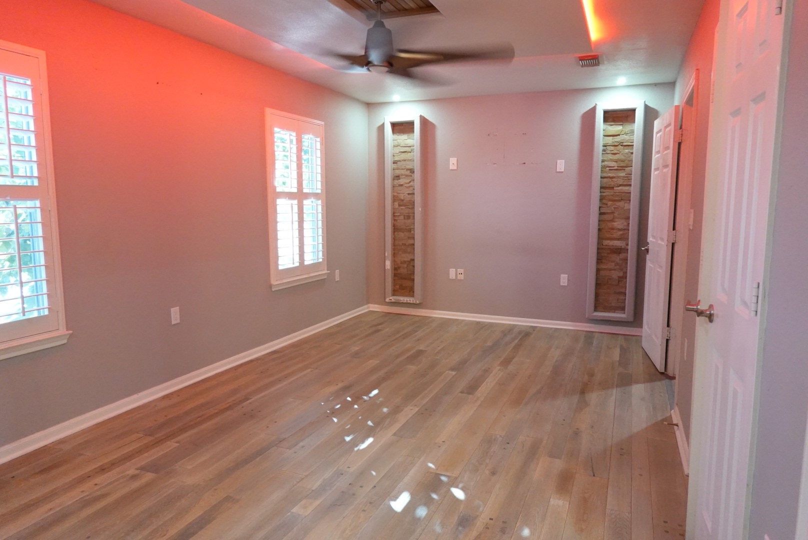 2714 Vienna Place Pasadena, TX 77502 - Photo 7 of 12 an empty room with wooden floor and windows