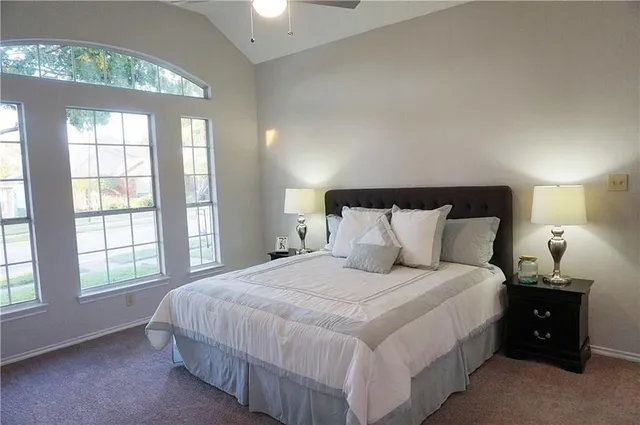 a bedroom with a bed and a window