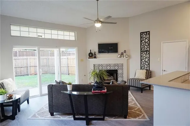 a living room with furniture a flat screen tv and a fireplace