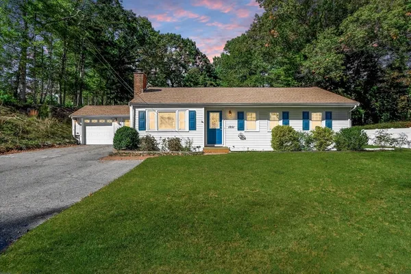 a front view of house with yard and green space