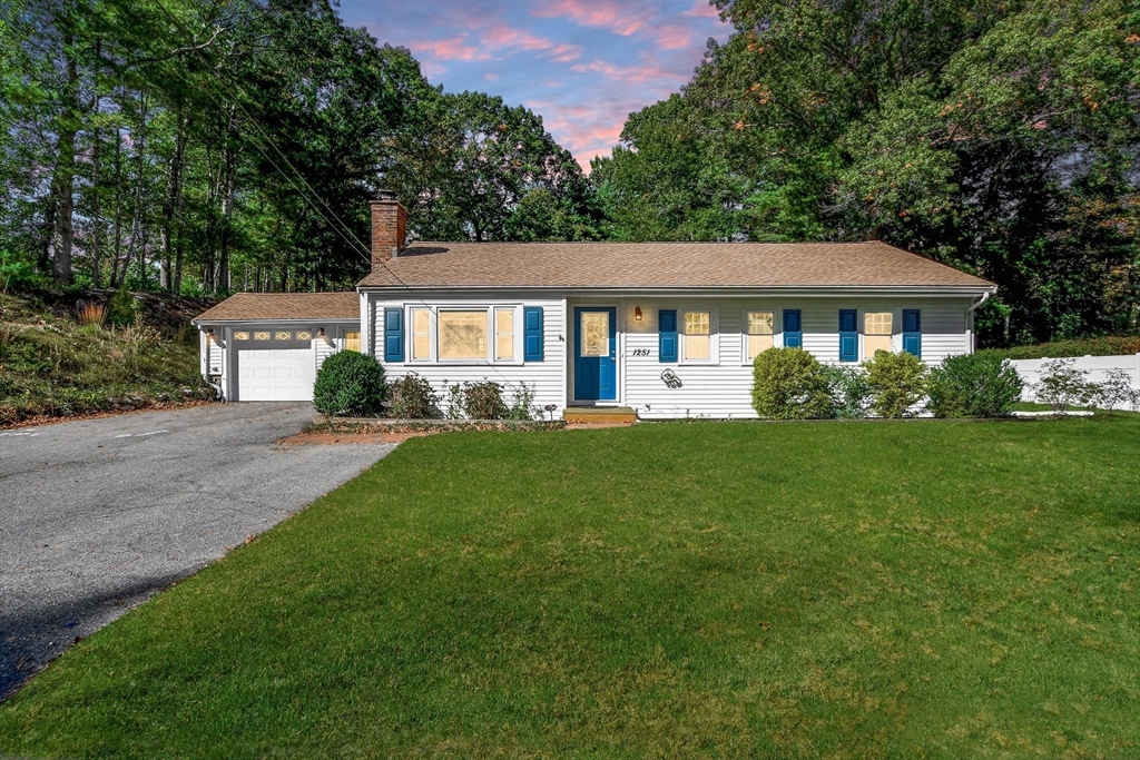a front view of house with yard and green space