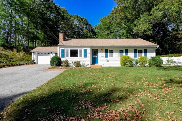 a front view of a house with garden
