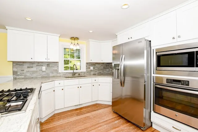 a kitchen with a refrigerator stove and microwave