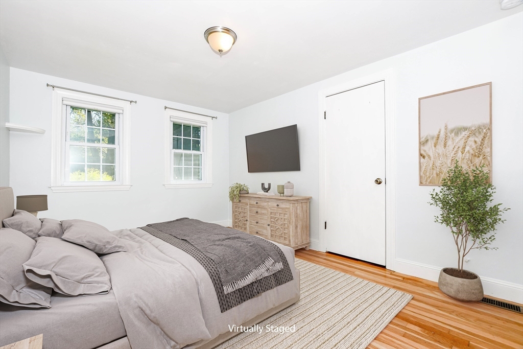 1251 Broadway Hanover, MA 02339 - Photo 16 of 39 a bedroom with a bed and a potted plant