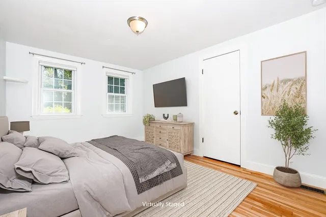 a bedroom with a bed and a potted plant
