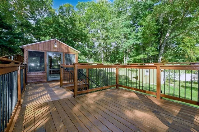 a view of a wooden deck with a yard