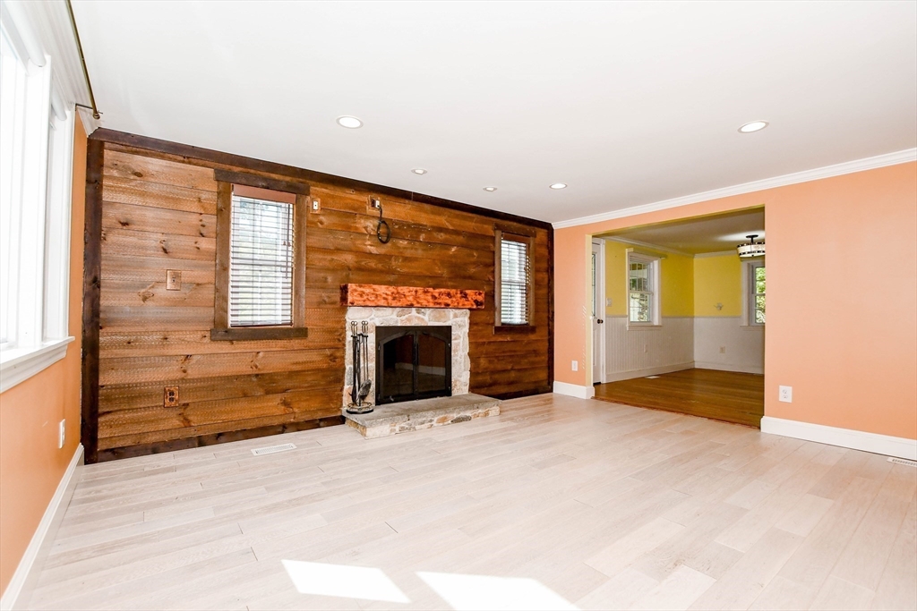1251 Broadway Hanover, MA 02339 - Photo 4 of 39 a view of an empty room with a fireplace and a window