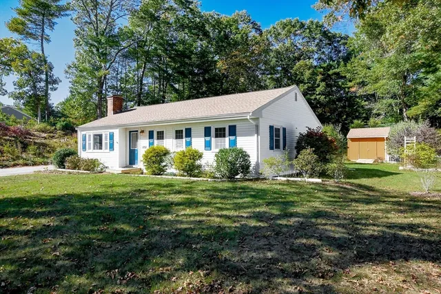 a front view of a house with a garden