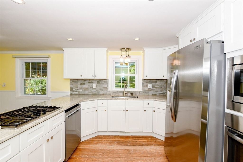 1251 Broadway Hanover, MA 02339 - Photo 9 of 39 a kitchen with a sink stove and refrigerator