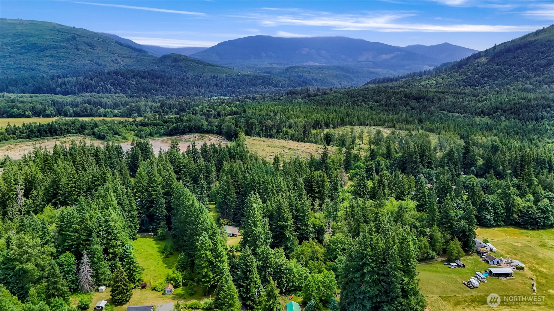 5650 Doran Road Acme, WA 98220 - Photo 13 of 40 a view of a lush green hillside and a building in the background