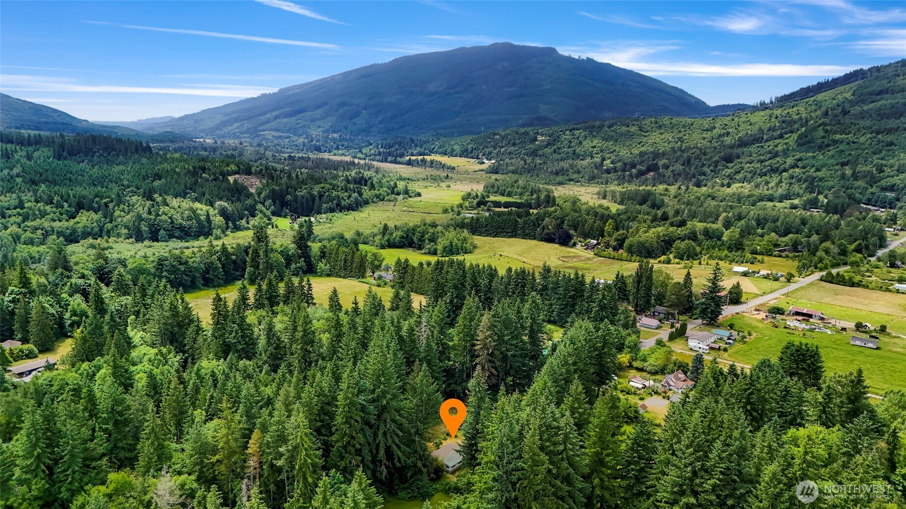5650 Doran Road Acme, WA 98220 - Photo 34 of 40 a view of a lush green hillside and a building in the background