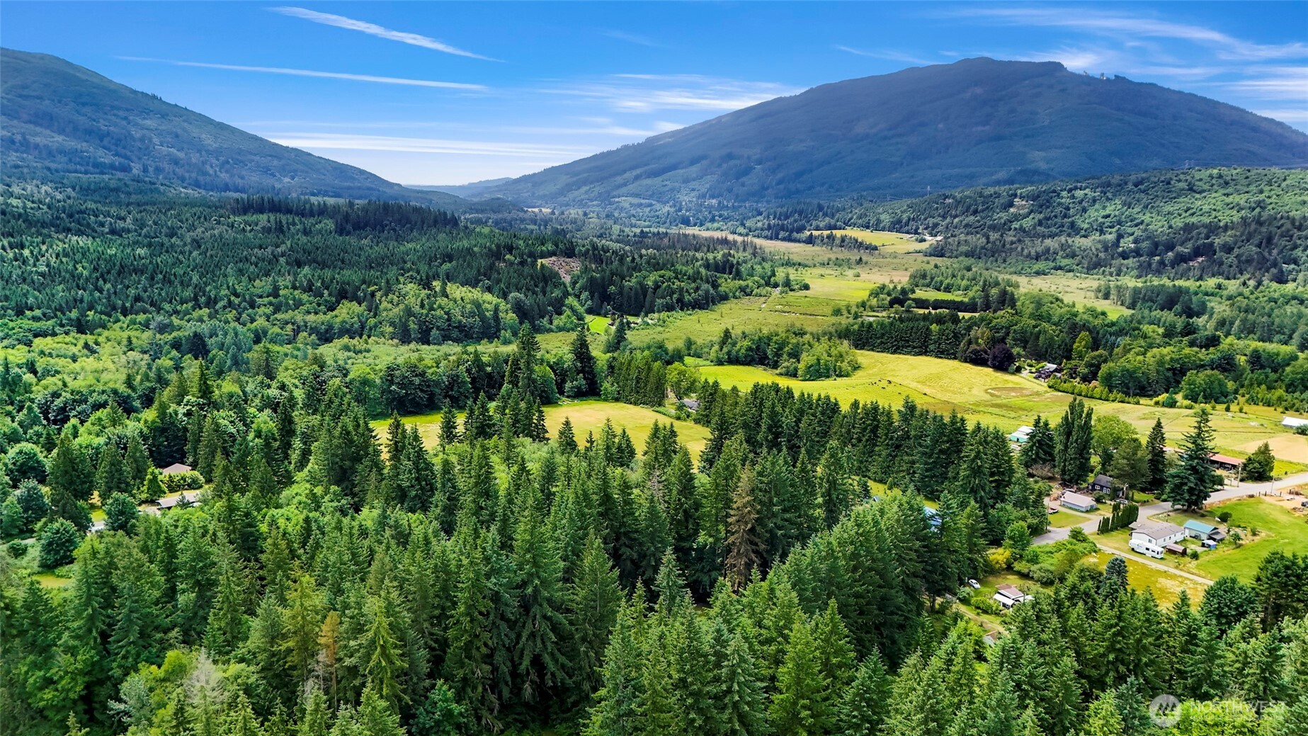 5650 Doran Road Acme, WA 98220 - Photo 4 of 40 a view of a lush green hillside and houses
