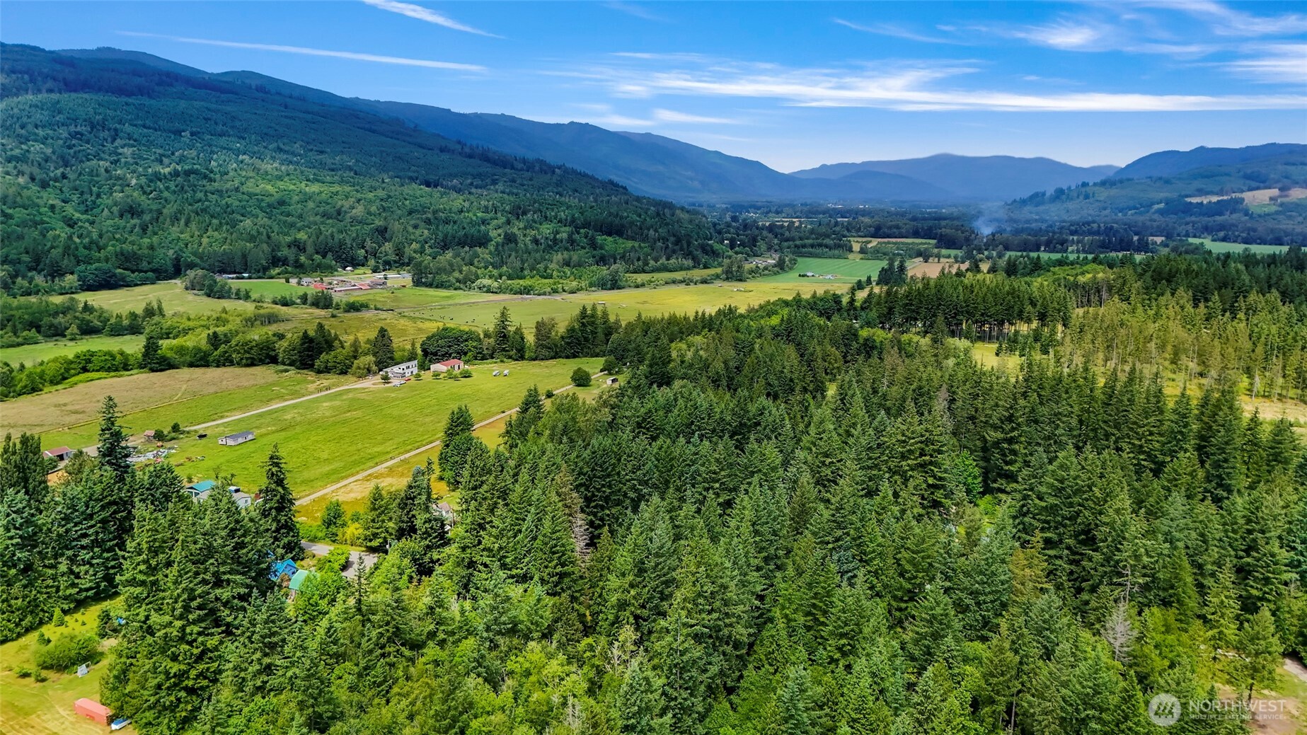 5650 Doran Road Acme, WA 98220 - Photo 9 of 40 a view of a lush green hillside and a houses