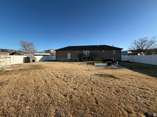 2095 West 4100 North Spring Glen, UT 84526 - Photo 26 of 35 Rear view of property featuring a patio area, and a fenced backyard.
