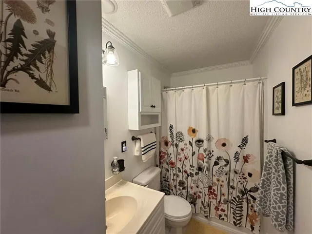 a white toilet sitting next to a bathroom sink