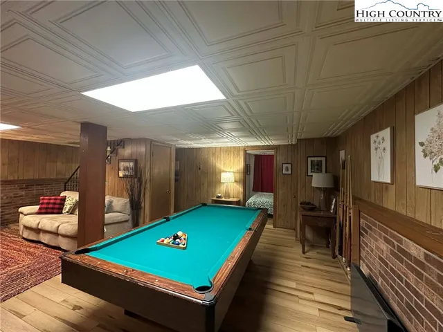 a room with pool table table and chairs