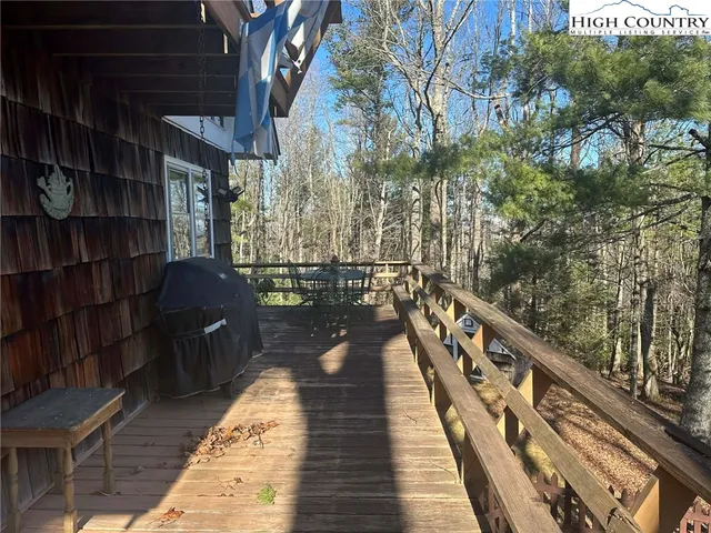 a view of balcony with wooden floor and seating space