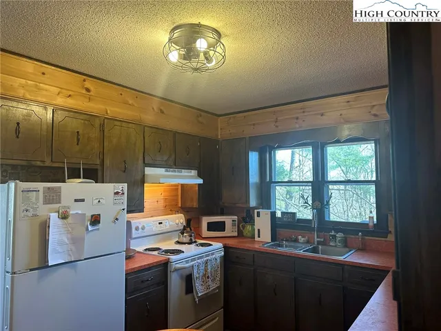 a kitchen that has a lot of cabinets and appliances