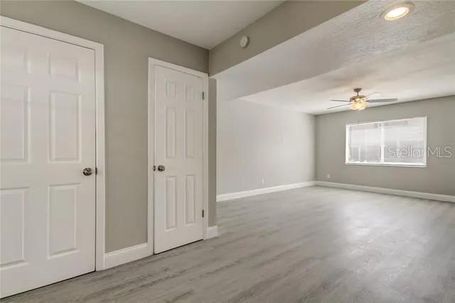 300 6th Street North, Unit W2 Safety Harbor, FL 34695 - Photo 11 of 22 a view of an empty room with wooden floor and a window