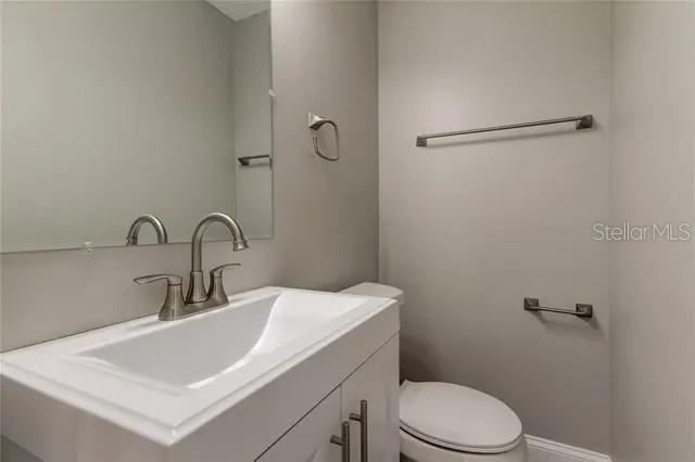 300 6th Street North, Unit W2 Safety Harbor, FL 34695 - Photo 12 of 22 a bathroom with a sink toilet and vanity