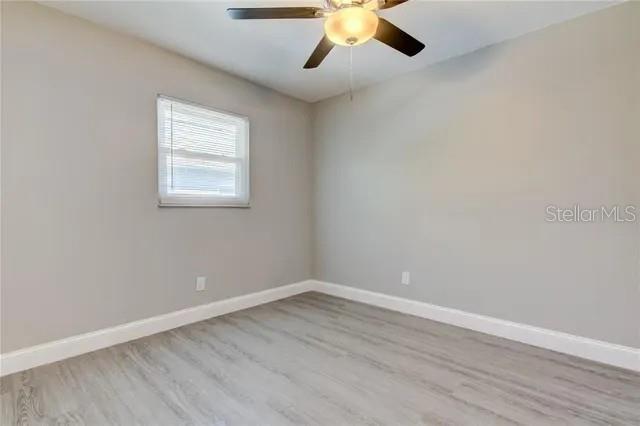 300 6th Street North, Unit W2 Safety Harbor, FL 34695 - Photo 15 of 22 a view of an empty room with wooden floor and a window
