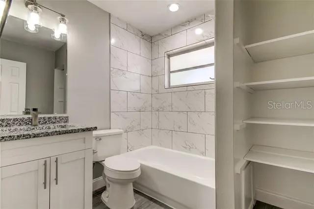 300 6th Street North, Unit W2 Safety Harbor, FL 34695 - Photo 17 of 22 a bathroom with a sink a toilet and shower